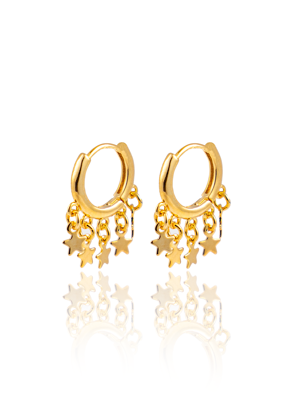 A pair of gold huggie hoop earrings featuring dangling star charms stands against a clean white background.