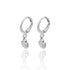A pair of silver hoop earrings featuring dangling seashell charms displayed against a white background with a subtle reflection.
