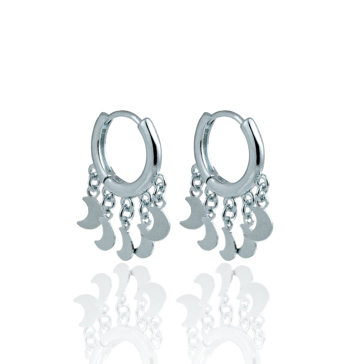 A pair of silver hoop earrings features dangling crescent moon charms against a clean white background.