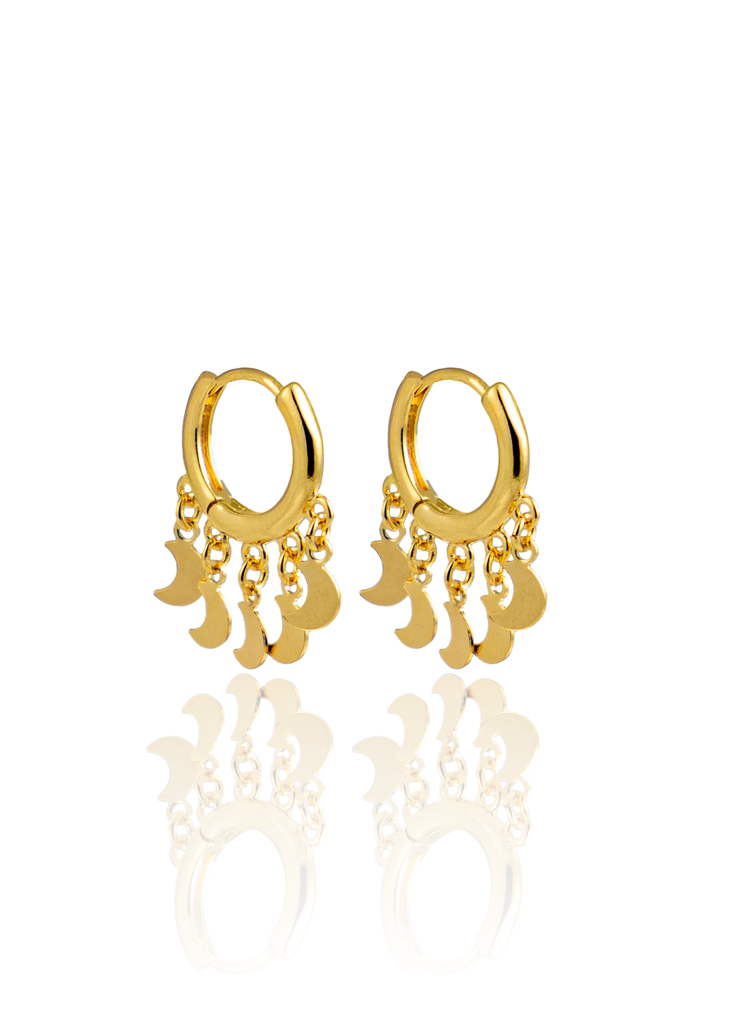 A pair of gold huggie hoop earrings features dangling crescent moon charms against a white background.