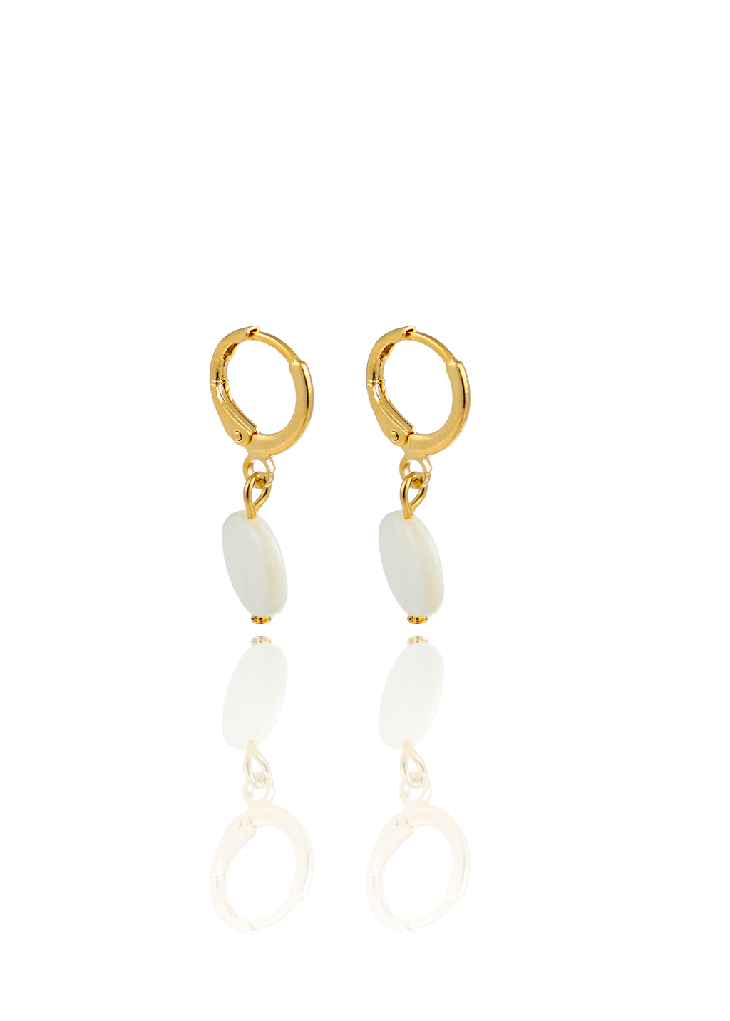 A pair of elegant gold hoop earrings featuring dangling white stone pendants is displayed against a clean white background with a soft reflection below.
