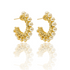 A pair of elegant gold wire-wrapped hoop earrings adorned with lustrous pearls rests against a white background, casting a soft reflection below.