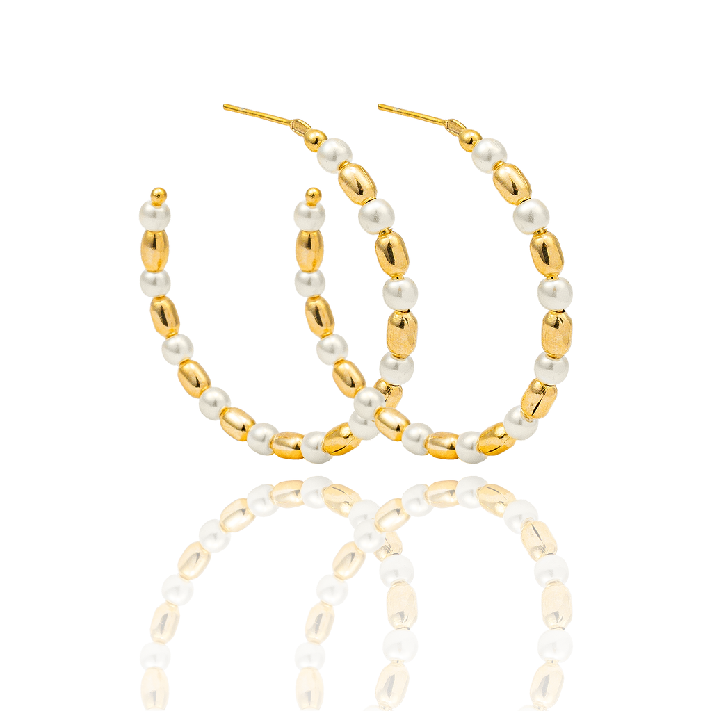 A pair of elegant gold hoop earrings adorned with alternating white pearls and textured gold beads sparkles against a clean white background.