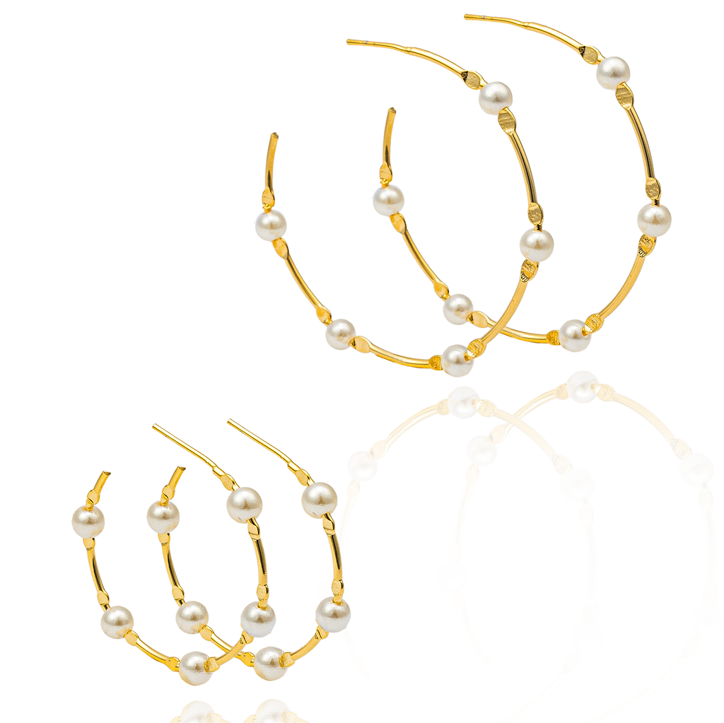 Two pairs of elegant gold hoop earrings accented with delicate white pearls display their glossy reflections on a clean white surface.