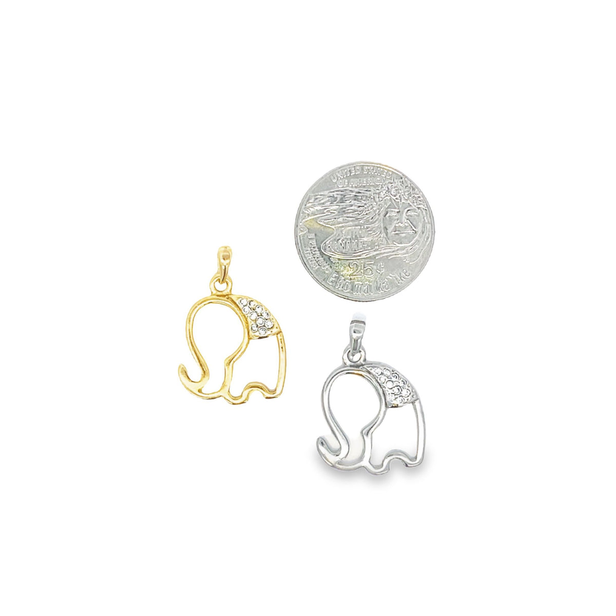 A gold and a silver elephant pendant with crystal-embellished ears lie next to a US quarter coin for size comparison on a white background.