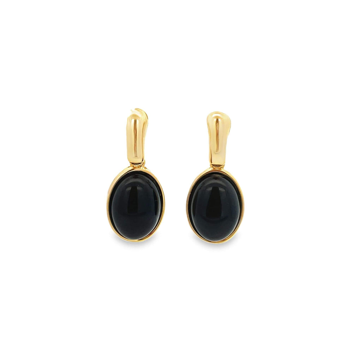 A pair of elegant gold-plated earrings featuring smooth, oval black stones rests against a plain white background.