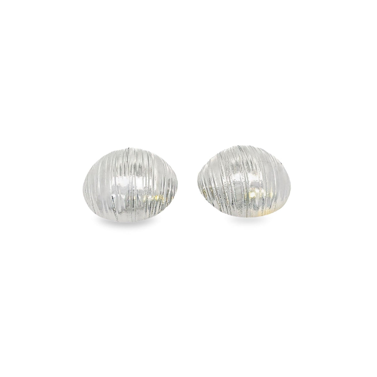 A pair of silver domed stud earrings features vertical ribbed texturing against a clean white background.