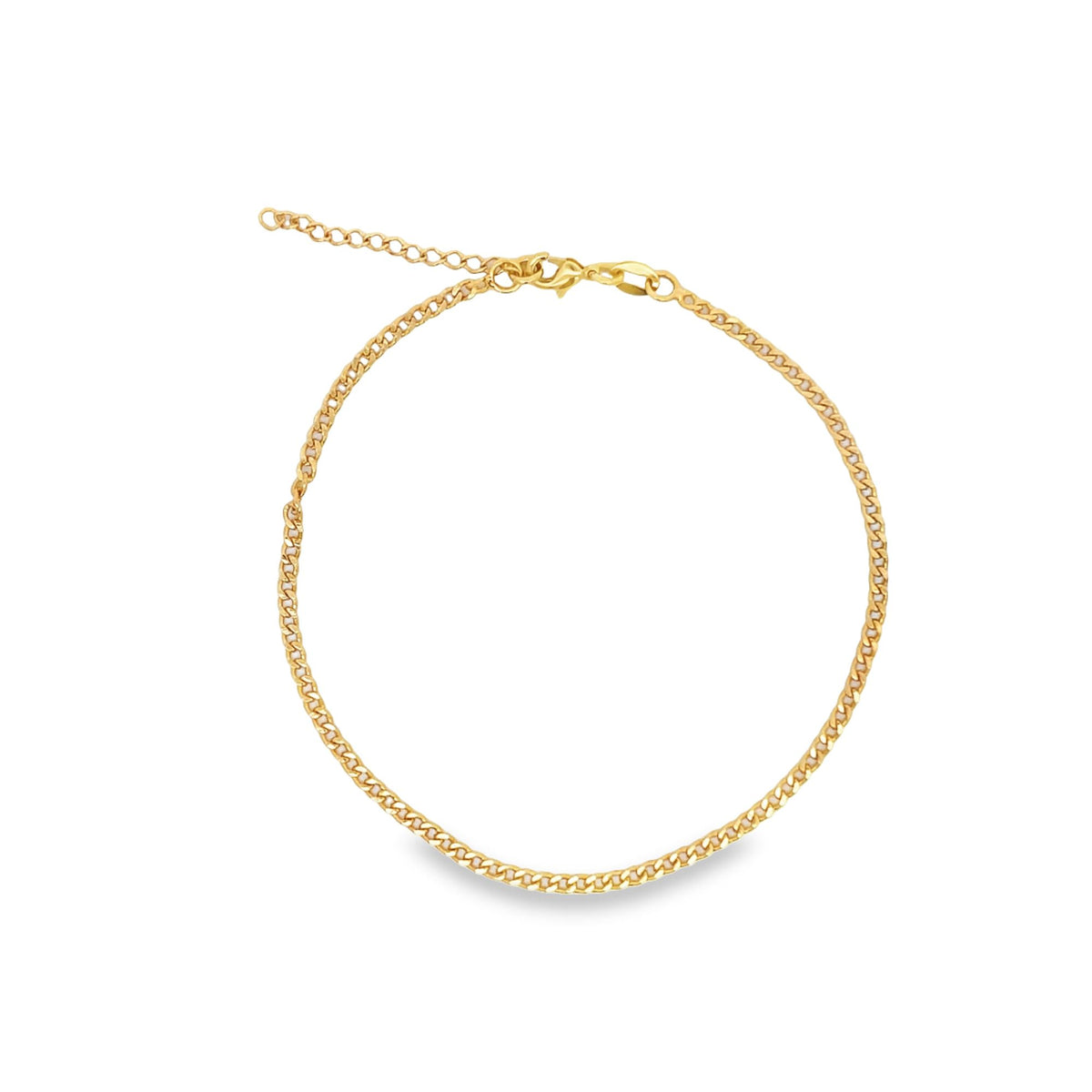 A delicate gold curb chain anklet rests in a circle against a white background, featuring an adjustable extension chain and a secure lobster clasp.