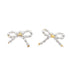 A pair of delicate pearl bow earrings features glossy white rice pearls shaped into bows with gold-tone centers against a clean white background.