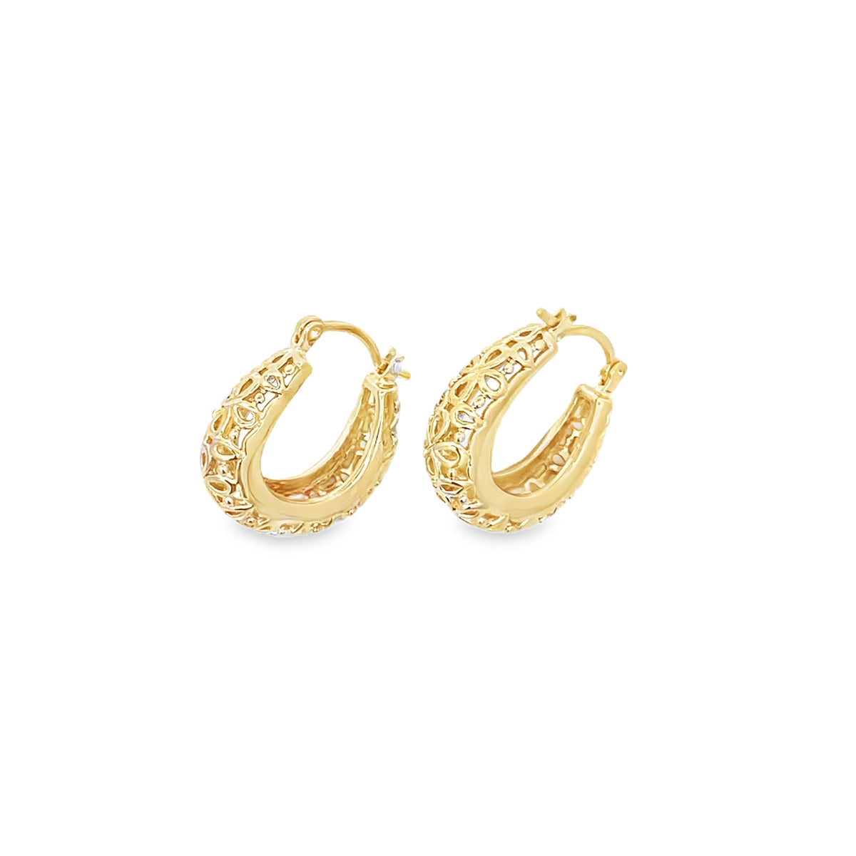 A pair of intricately designed gold filigree hoop earrings sits upright against a clean white background.