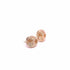 A pair of gold wire-wrapped knot stud earrings rests on a clean white surface.