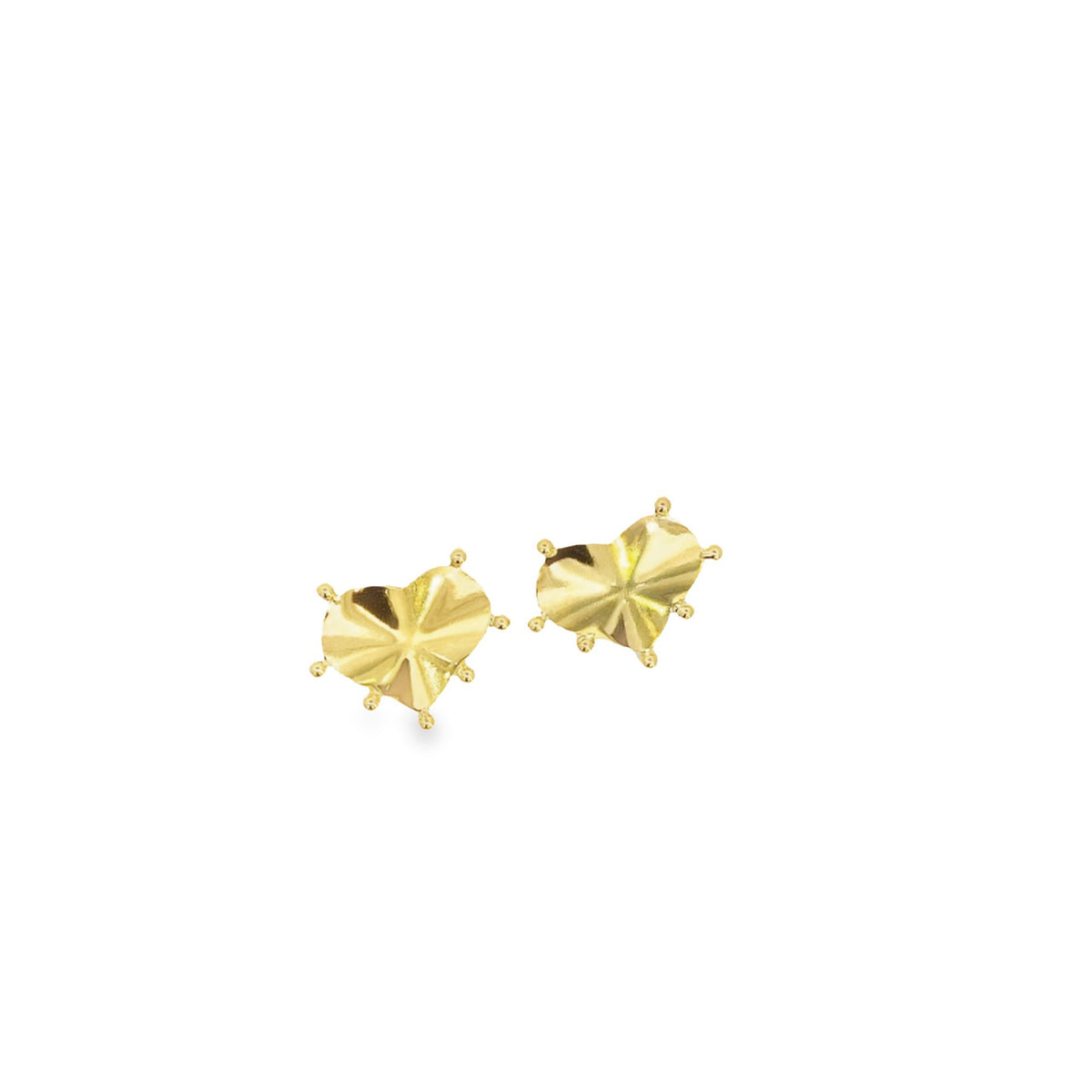 A pair of gold heart-shaped stud earrings featuring faceted surfaces rests against a plain white background.