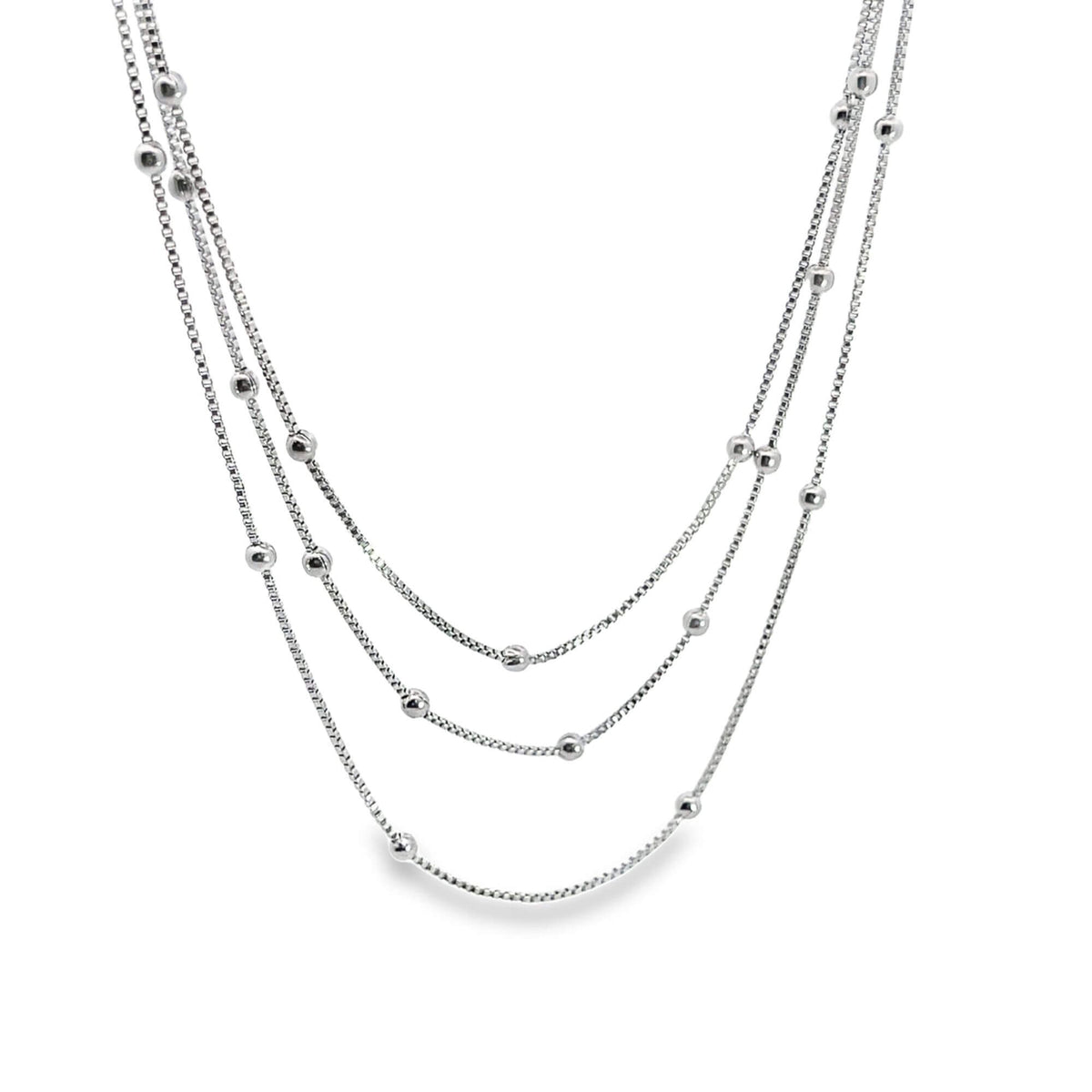 A delicate multi-strand silver necklace features dangling spherical beads along each dainty chain.