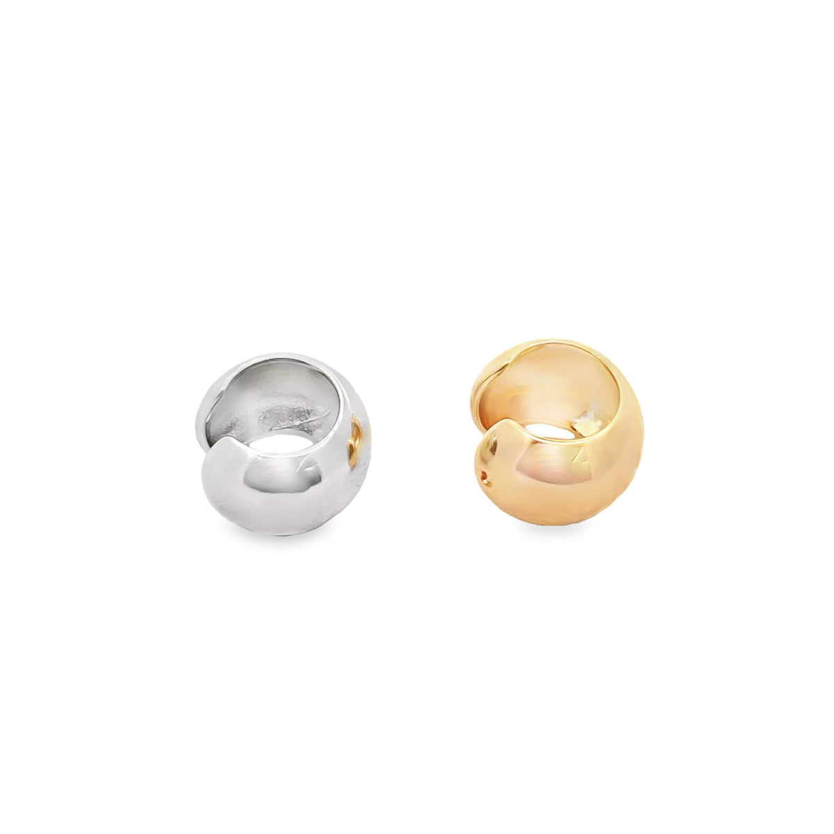Two minimalist chunky ear cuffs, one in silver and one in gold, rest side by side against a clean white background.