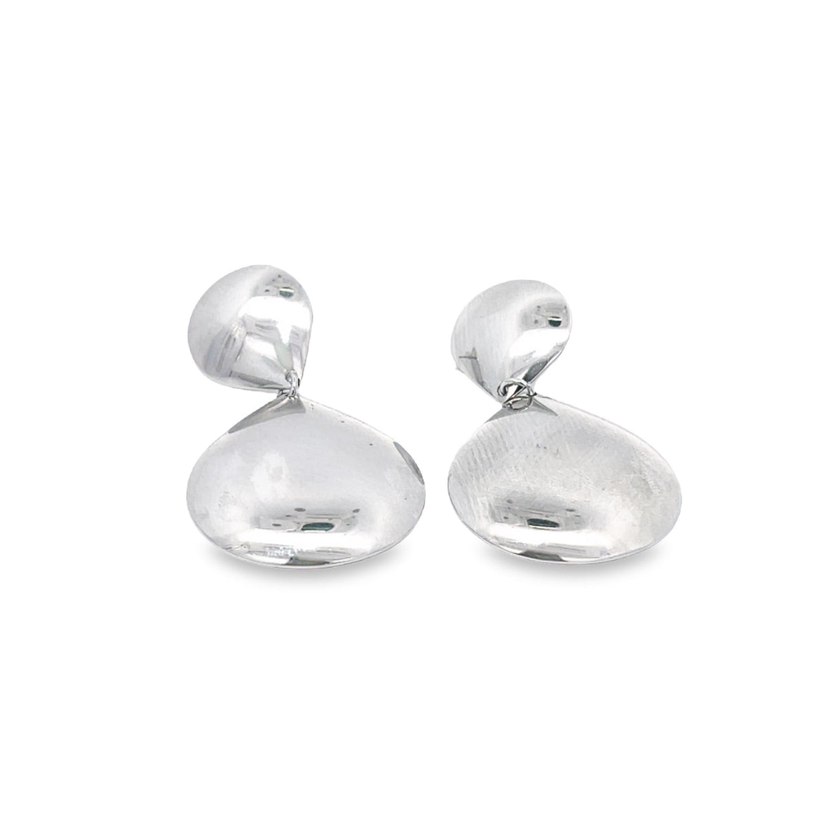 A pair of sleek, silver drop earrings featuring polished, organic pebble-shaped pendants dangle against a clean white background.