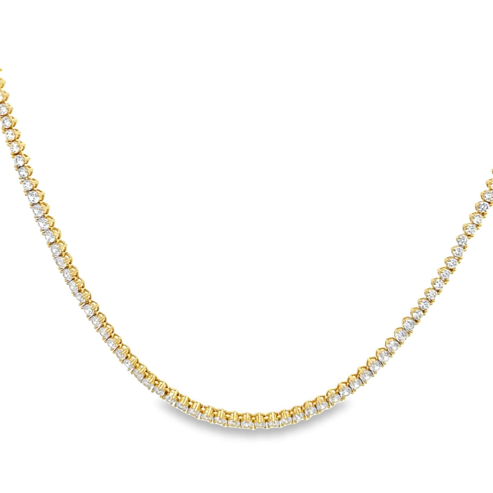 A sparkling gold tennis necklace features a continuous line of brilliant-cut diamonds against a clean white background.