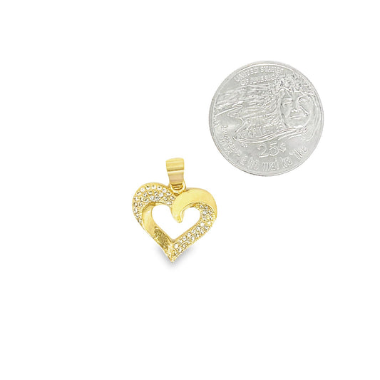 A sparkling gold heart-shaped pendant rests next to a quarter coin for size comparison.