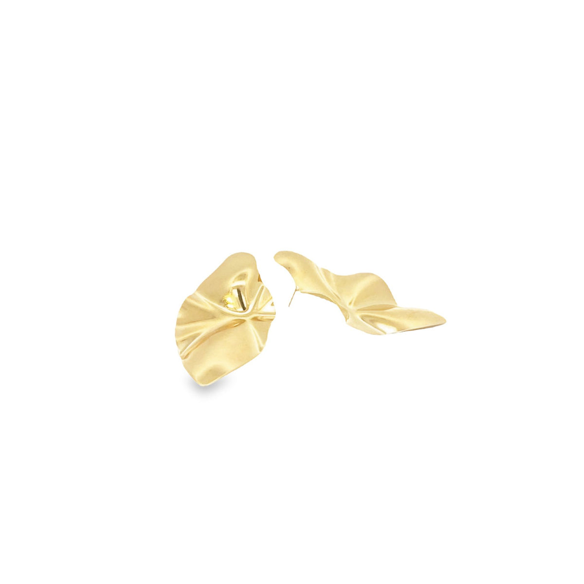 A pair of gold abstract sculpted statement earrings rests against a clean white background.
