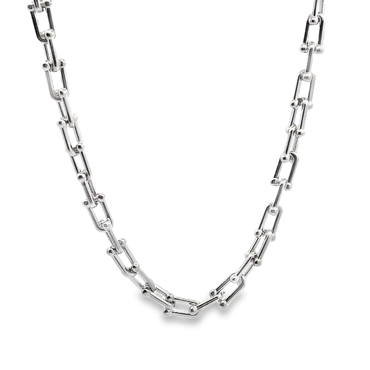 A gleaming silver hard-wear link necklace drapes in a smooth curve against a clean white background.