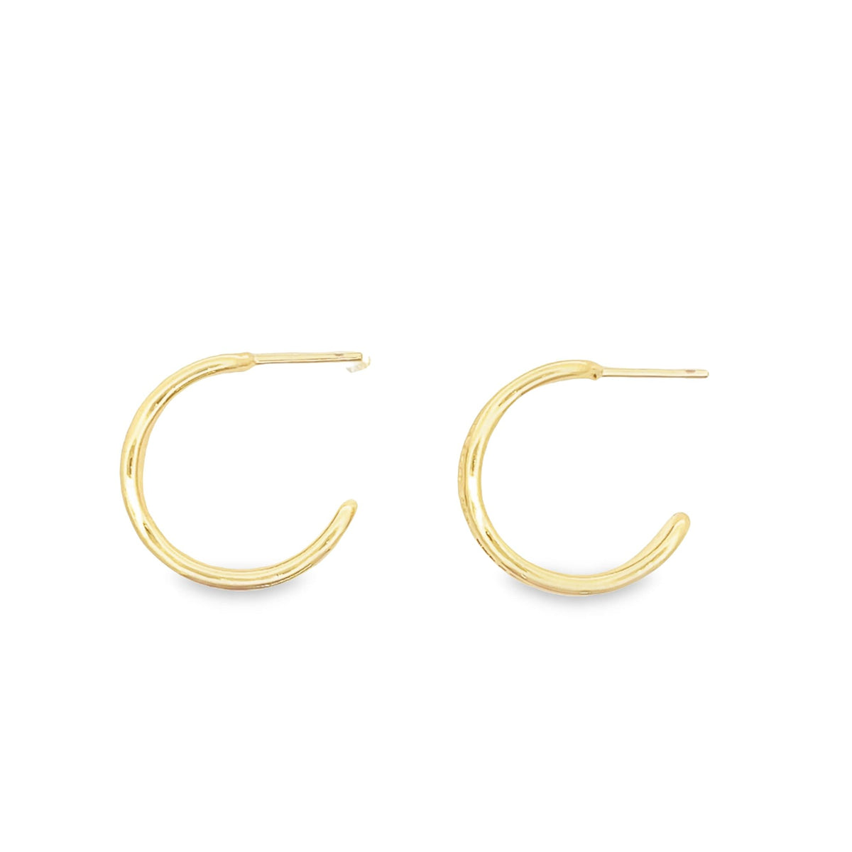 A pair of sleek gold hoop earrings rests against a clean white background.