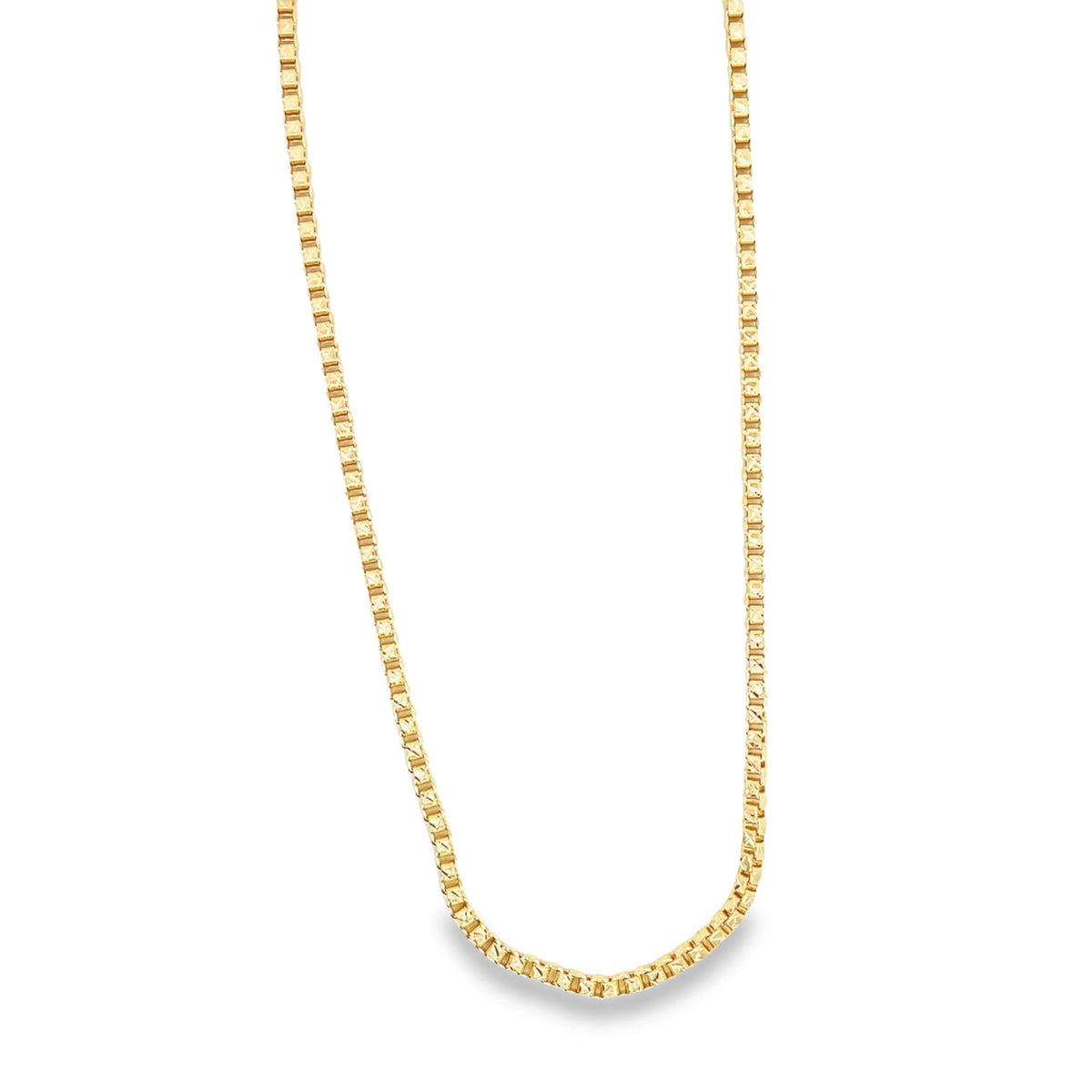 A gleaming yellow gold box chain necklace hangs in a graceful curve against a clean white background.