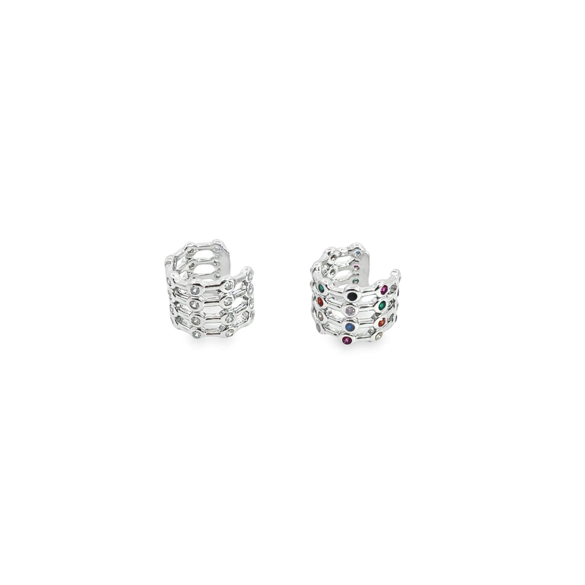 Two silver multi-band ear cuffs sparkle against a clean white background, showcasing intricate geometric designs encrusted with clear and multicolored gemstones.