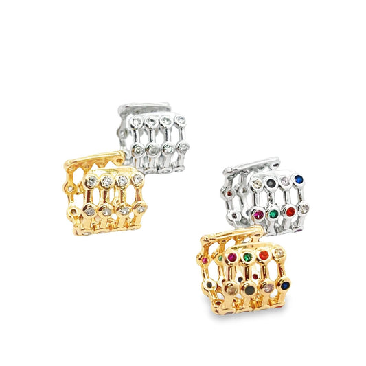 Four multi-row hoop earrings in gold and silver, encrusted with clear and colorful gemstones, are displayed against a clean white background.
