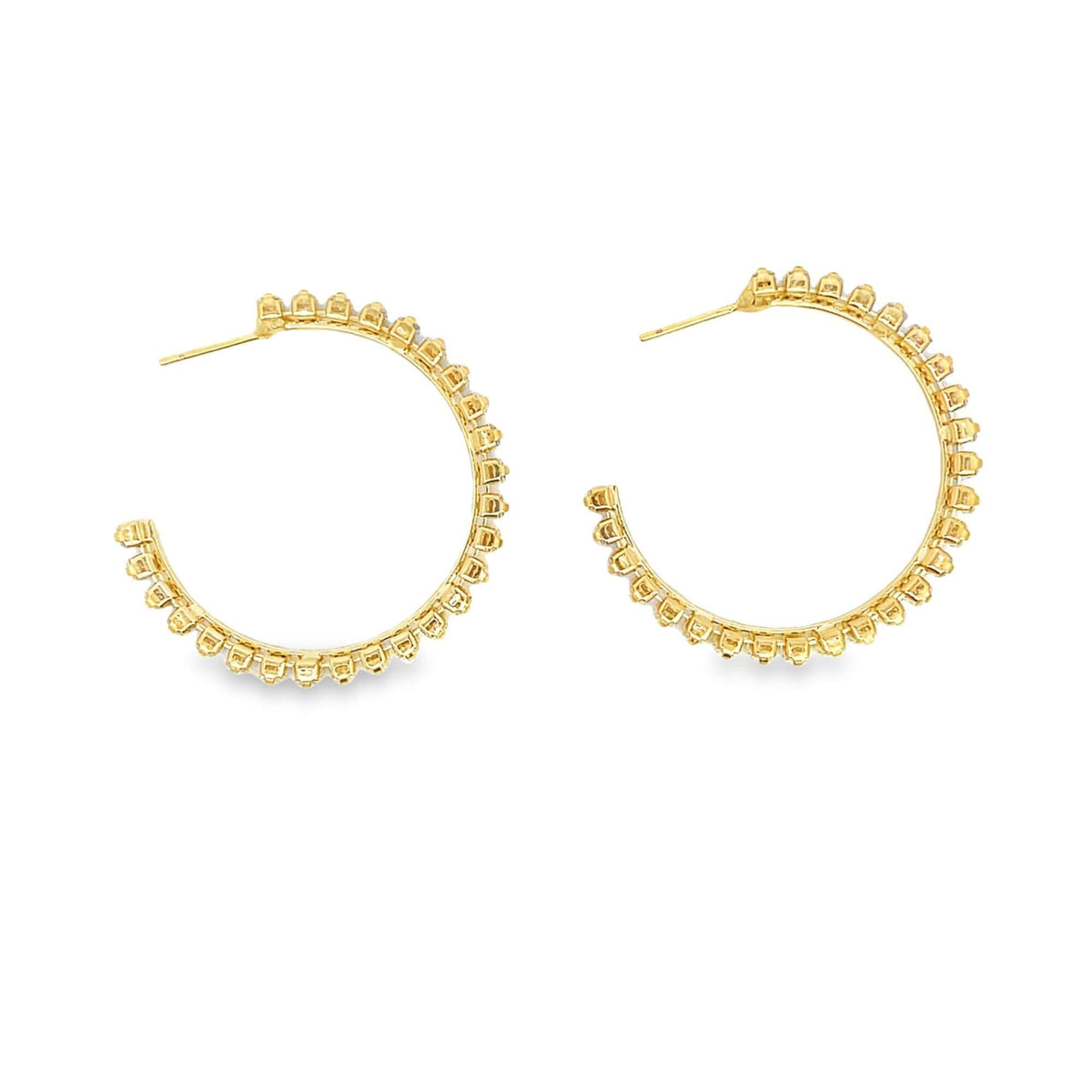 A pair of dazzling gold hoop earrings sparkles against a clean white background.