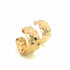 A pair of thick, hammered gold hoop earrings rests against a clean white background.