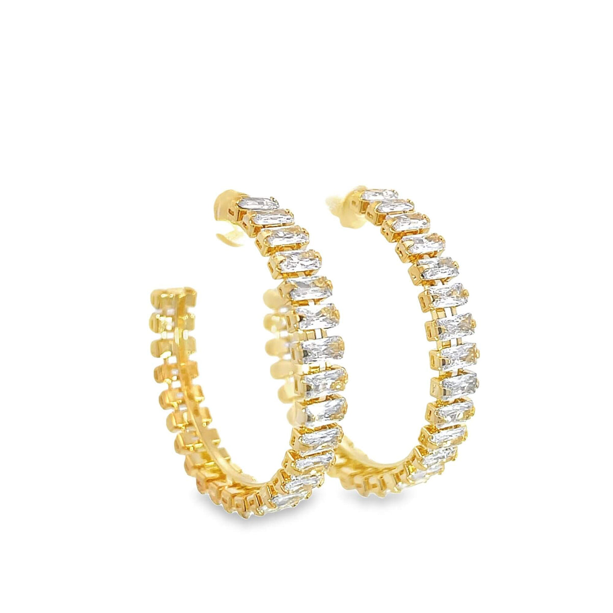 A pair of gleaming gold hoop earrings features a continuous row of sparkling baguette-cut diamonds.