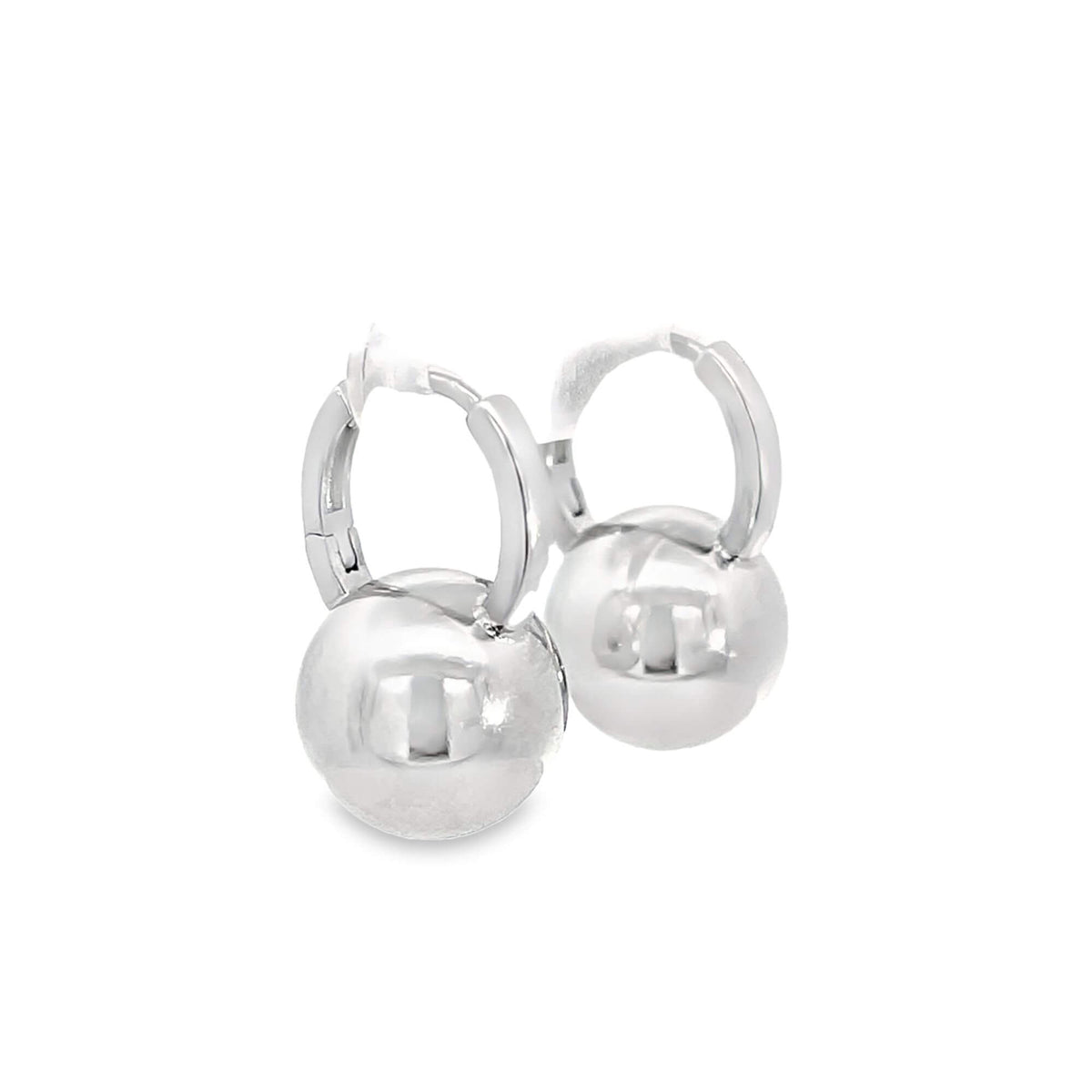 A pair of polished silver ball hoop earrings gleams against a plain white background.