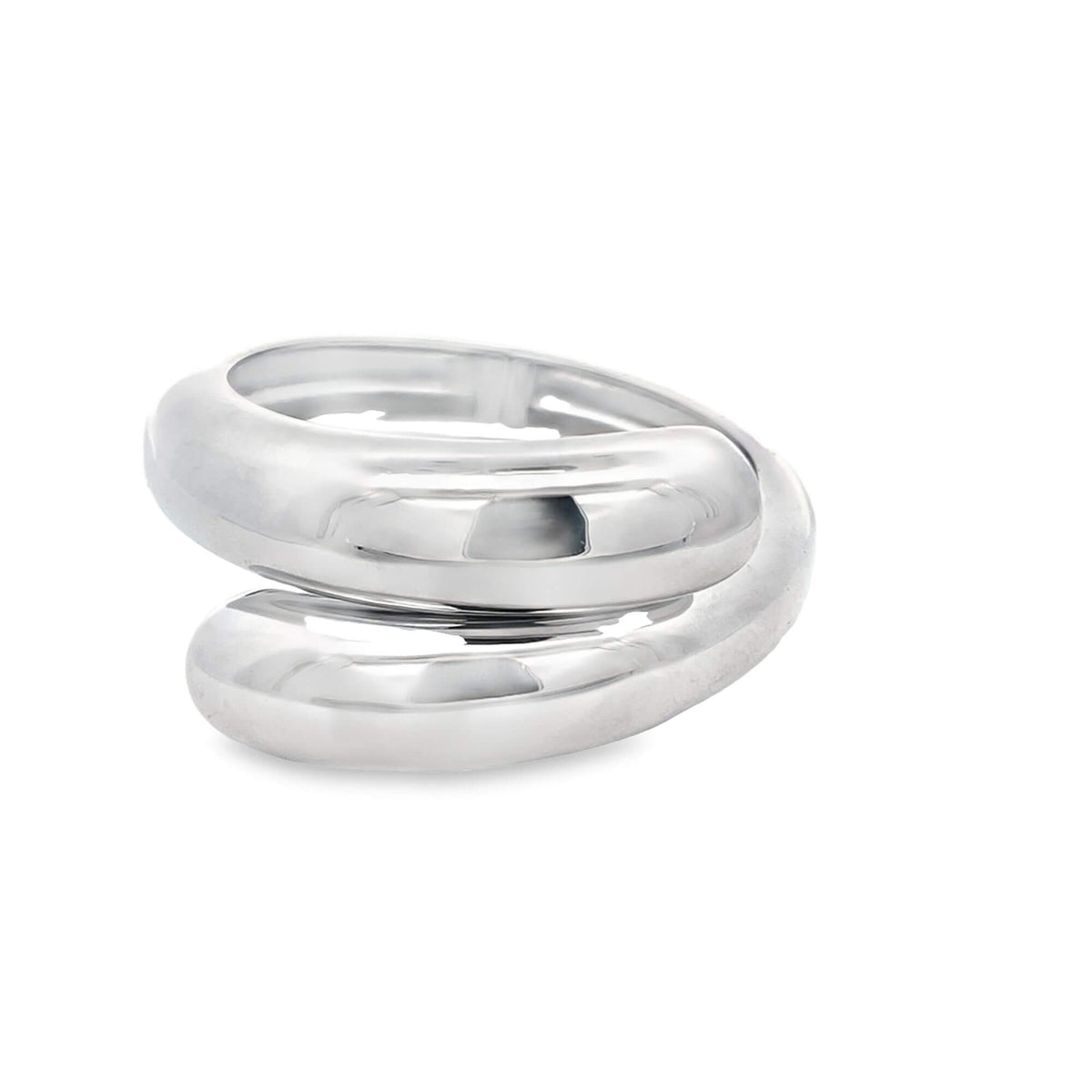 A thick, polished silver bypass ring sits against a clean white background.
