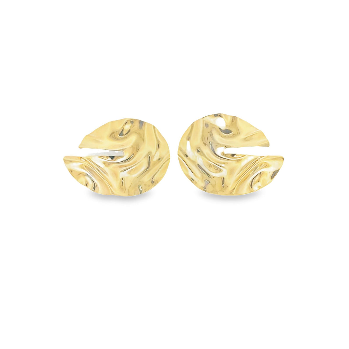 A pair of gold abstract hammered disc earrings rests against a white background.
