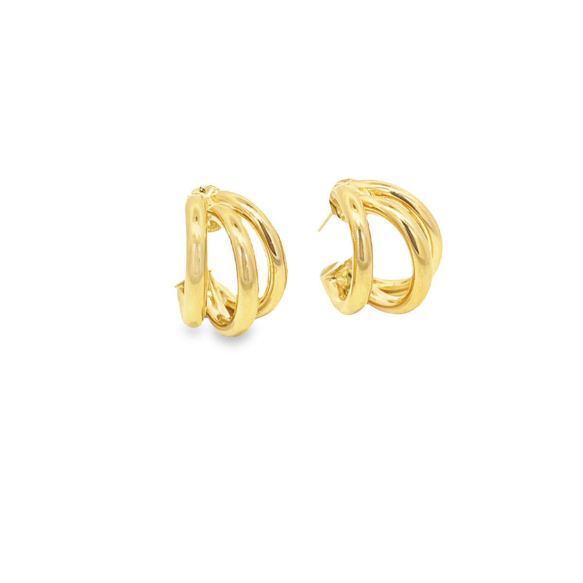 A pair of gleaming gold triple hoop earrings rests against a clean white background.