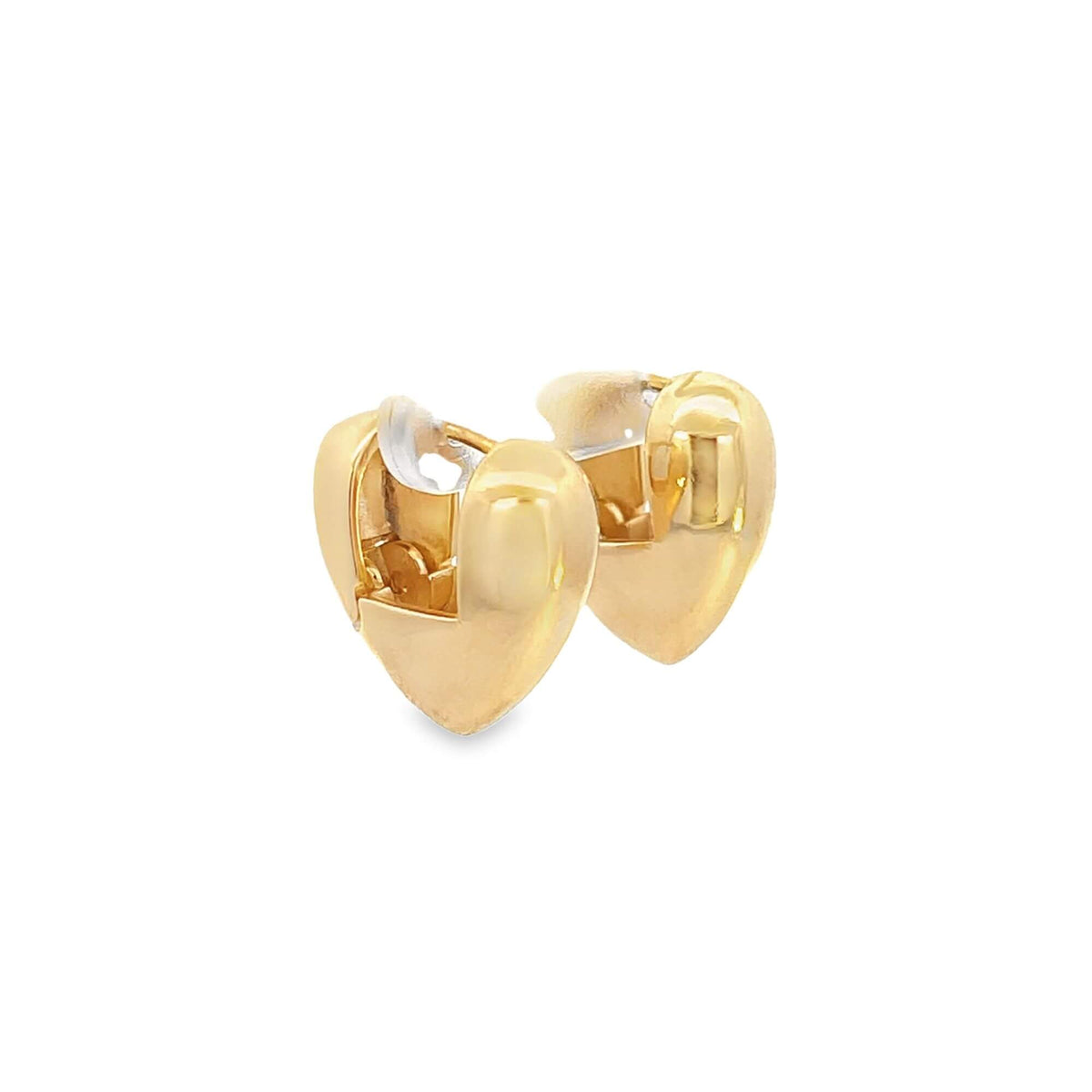 A pair of shiny gold heart-shaped huggie hoop earrings sit against a plain white background.