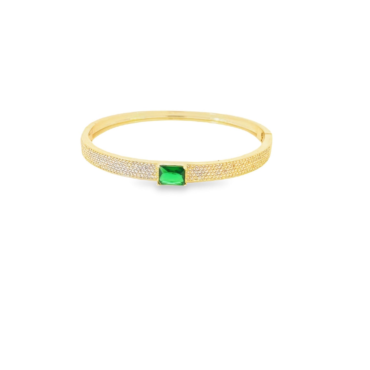 A gold pavé bangle bracelet features a vibrant emerald-cut green gemstone at the center against a clean white background.