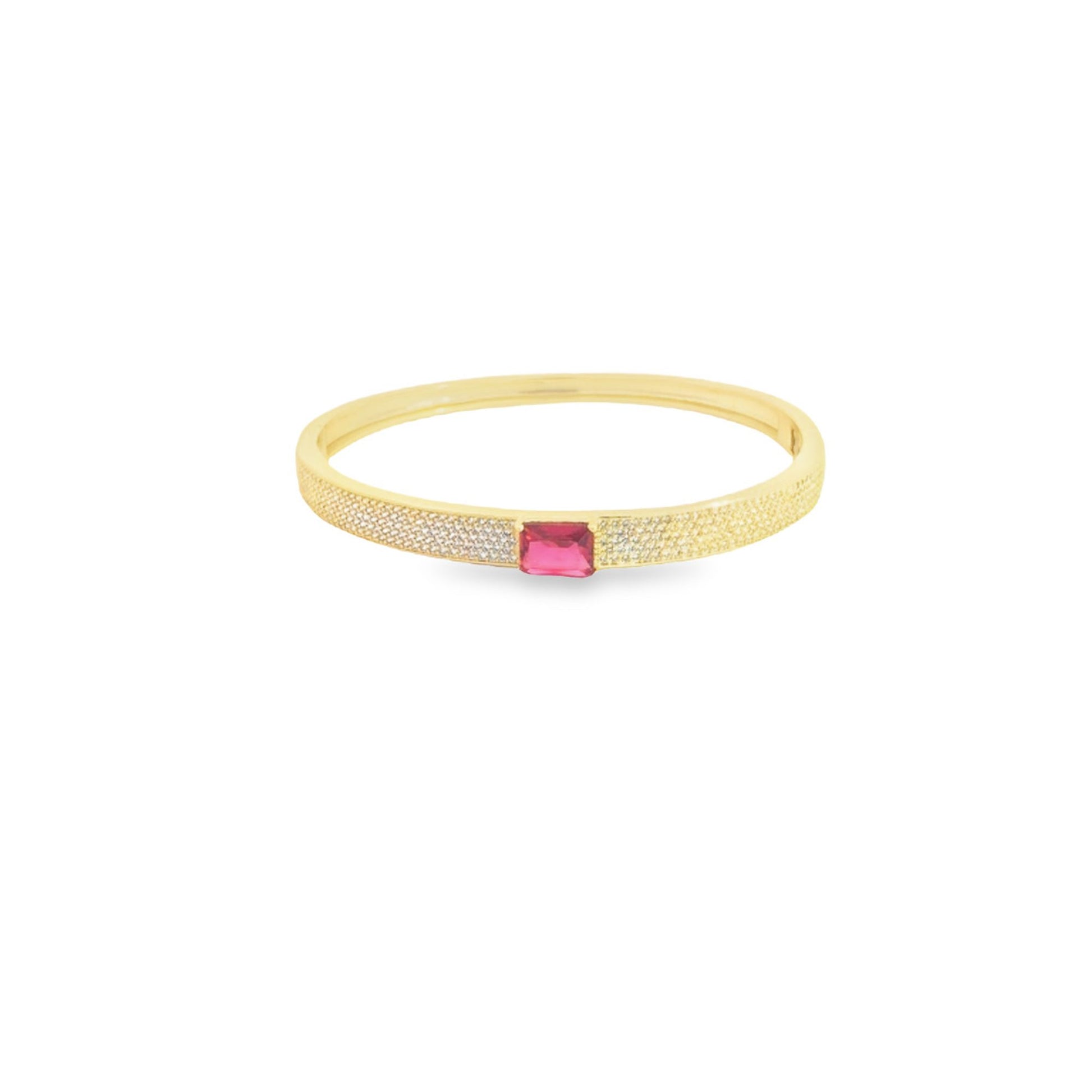 A gold bangle bracelet sparkles with pavé diamonds and features a vibrant rectangular pink gemstone at its center.