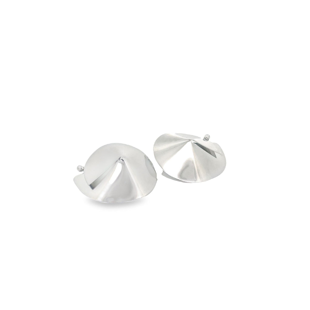 A pair of shiny silver dome-shaped statement earrings rests against a clean white background.