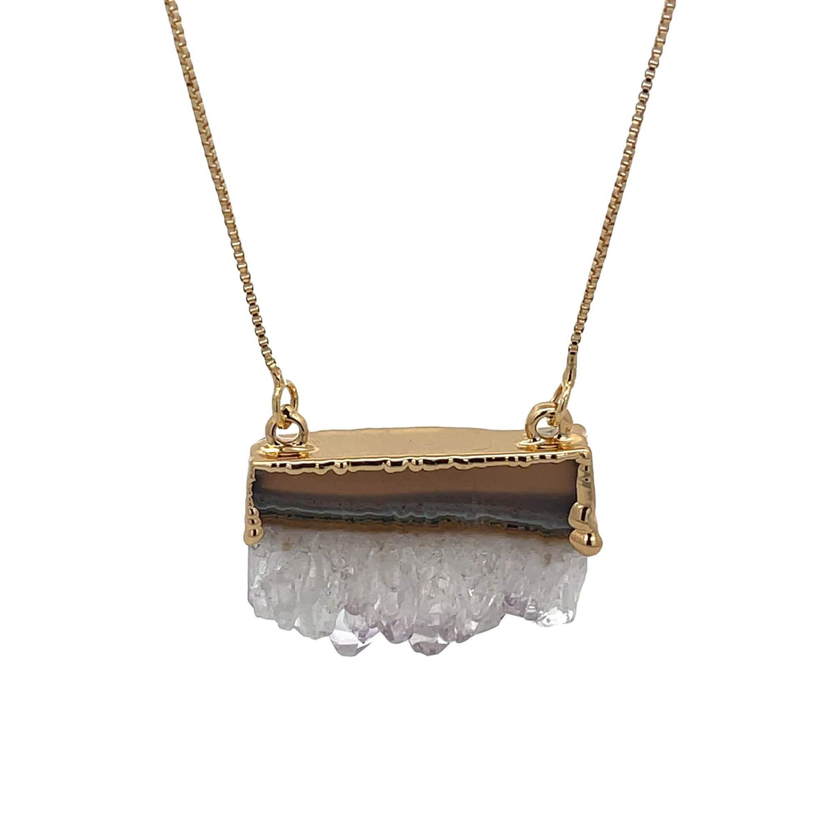 A gold-plated chain necklace displays a rectangular crystal pendant with layered brown and white quartz mineral formations.