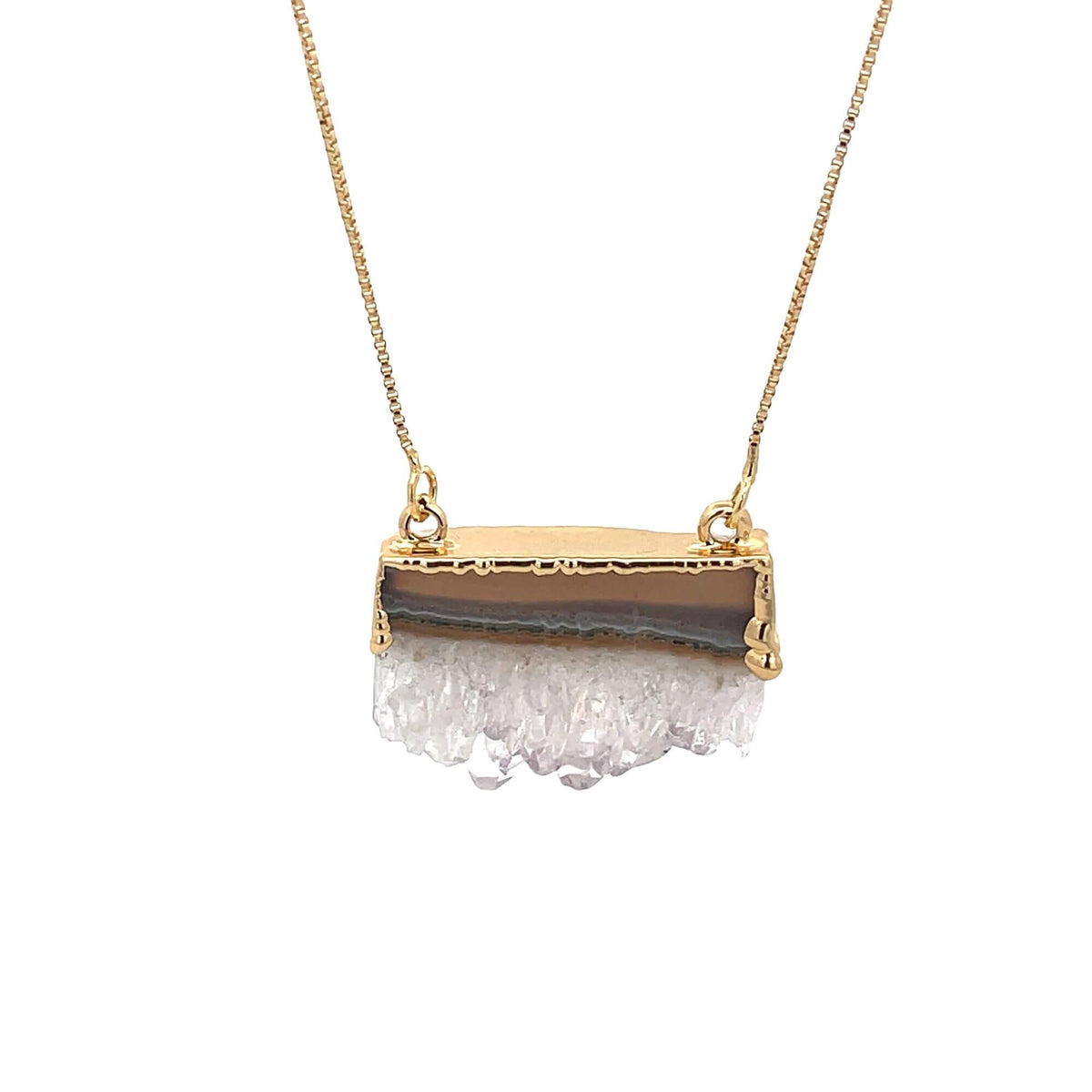 A delicate gold chain holds a rectangular pendant featuring a brown banded agate gemstone topped with raw white crystals.