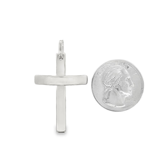 A sleek silver cross pendant is displayed next to a US quarter coin for size comparison.