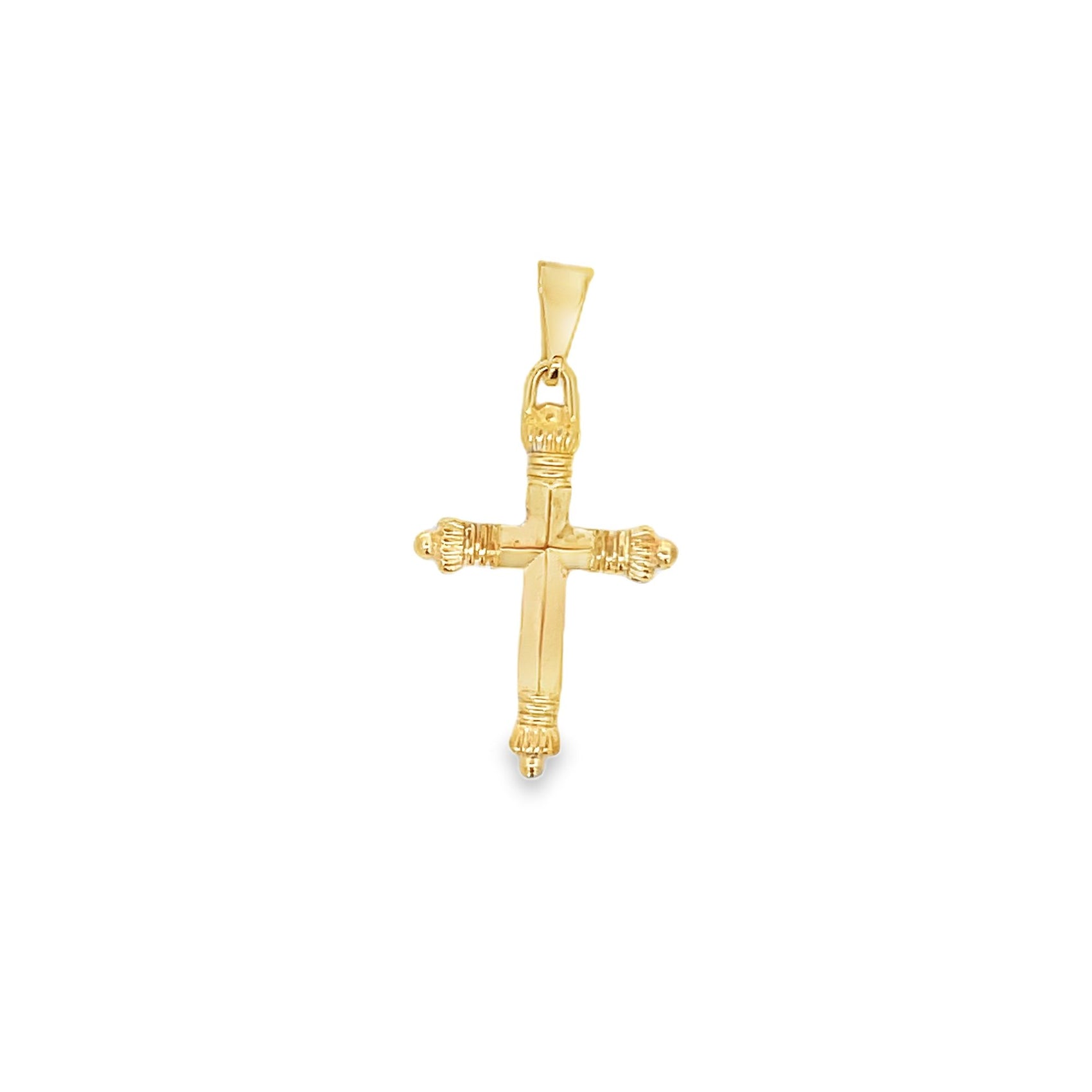 A polished yellow gold cross pendant features ornate textured detailing on the ends against a clean white background.