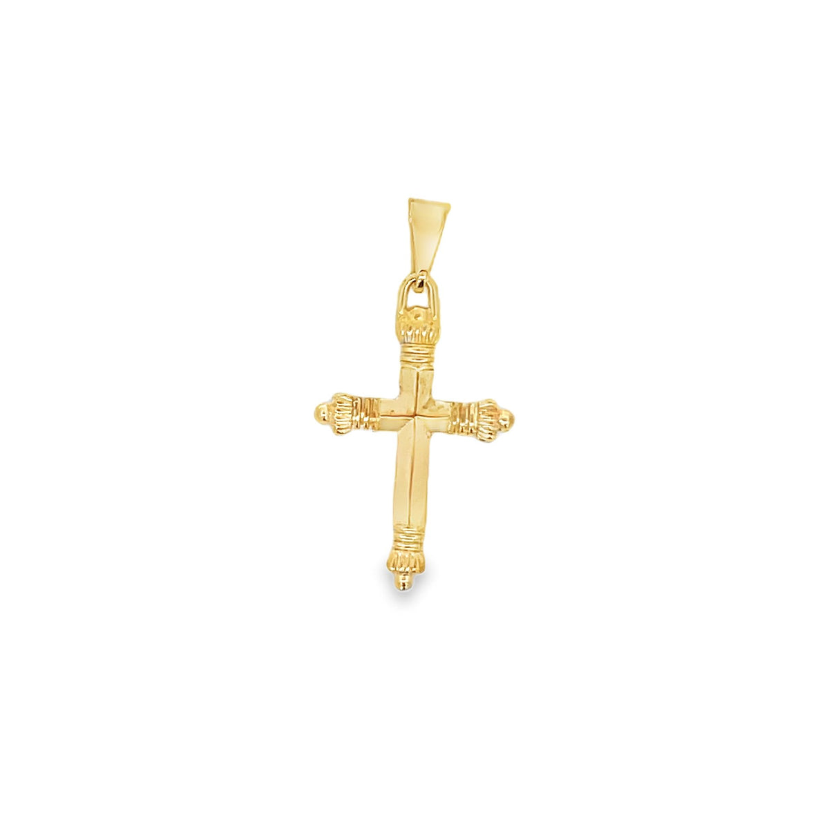A polished yellow gold cross pendant features ornate textured detailing on the ends against a clean white background.