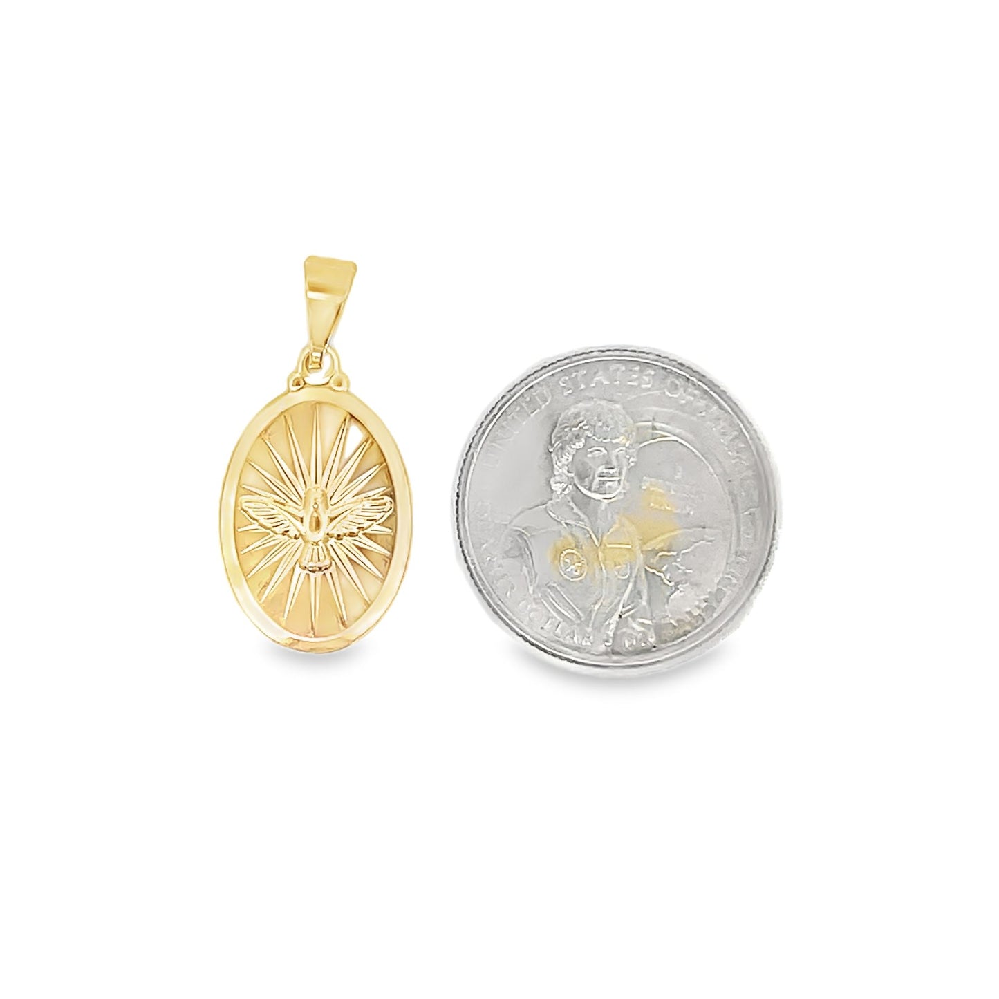A gold Holy Spirit dove pendant rests next to a US dollar coin to display its actual size.