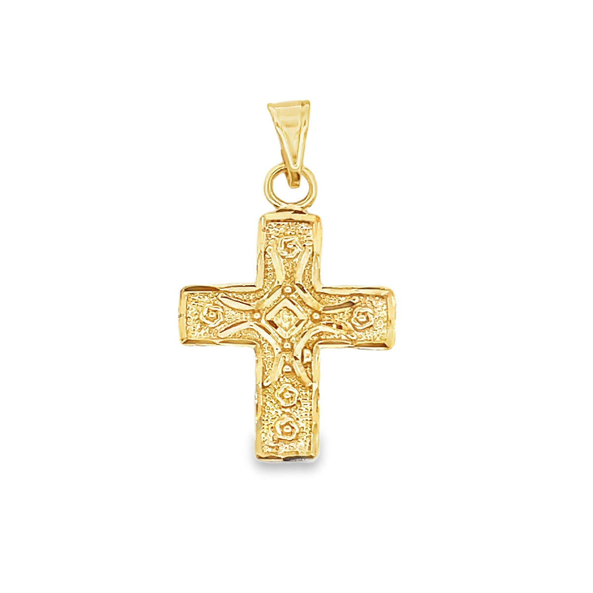 A detailed gold cross pendant features intricate engraved floral and geometric patterns against a textured background.