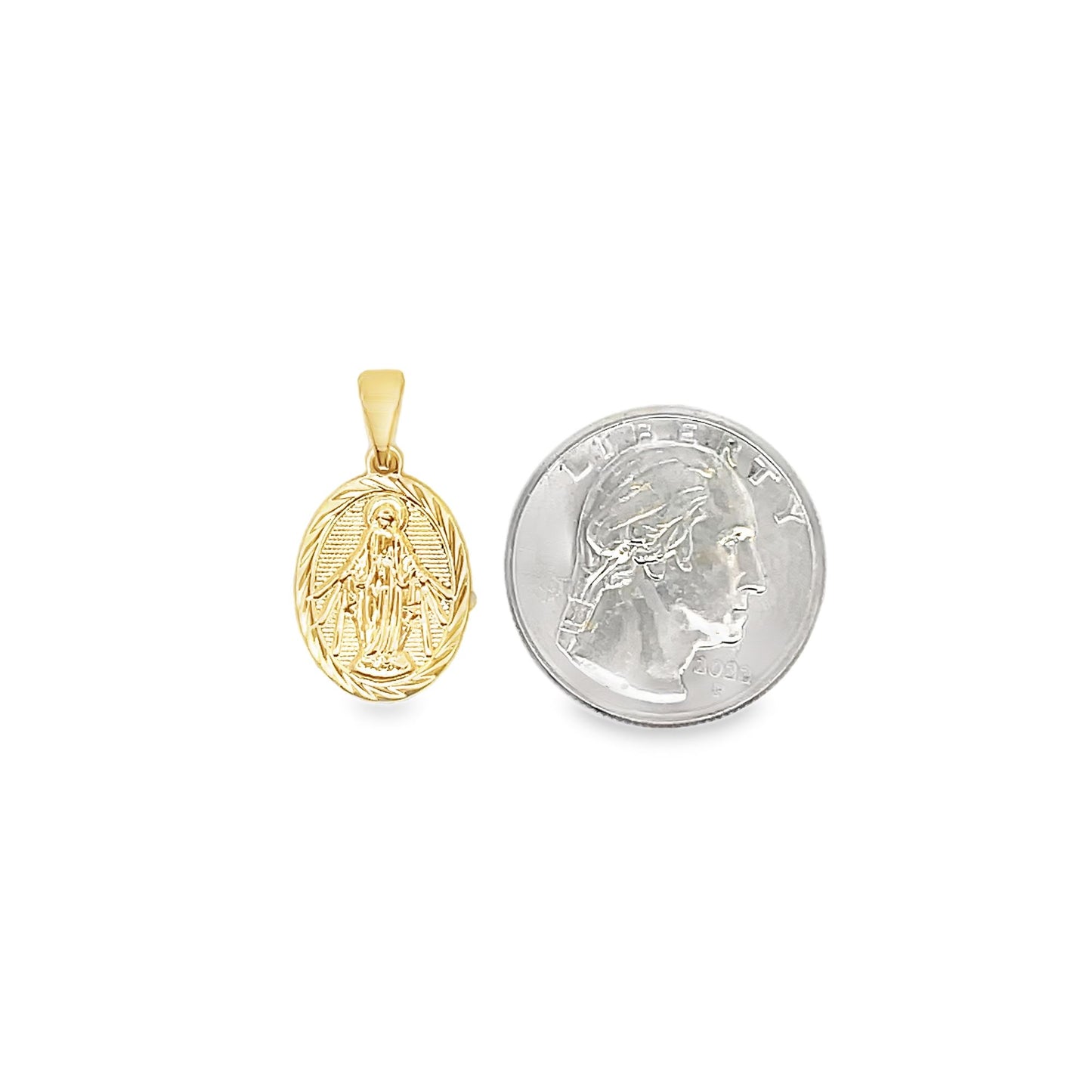 A small gold Miraculous Medal pendant rests beside a US quarter to demonstrate its scale.