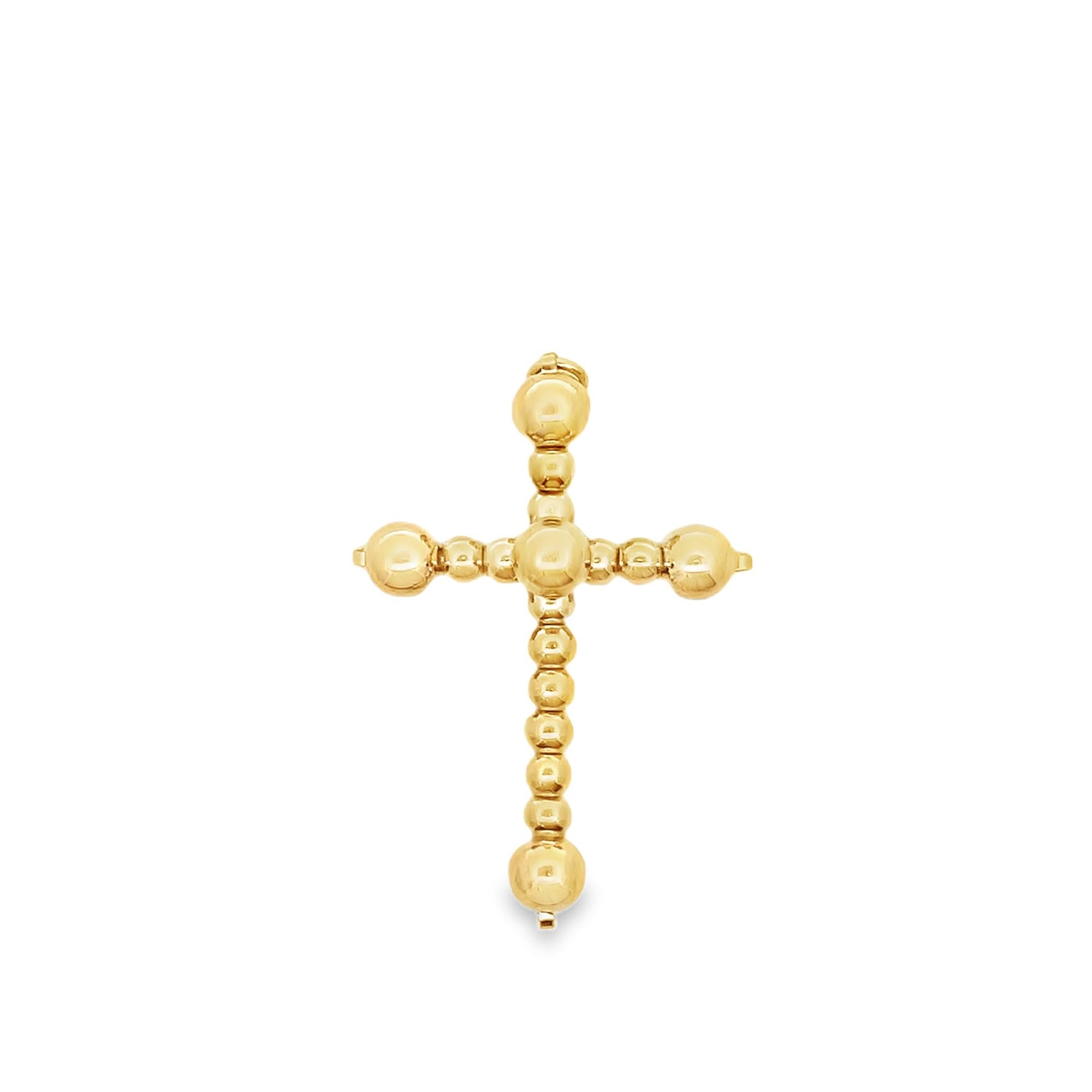 A shiny gold cross pendant features a textured design made of small spherical beads.
