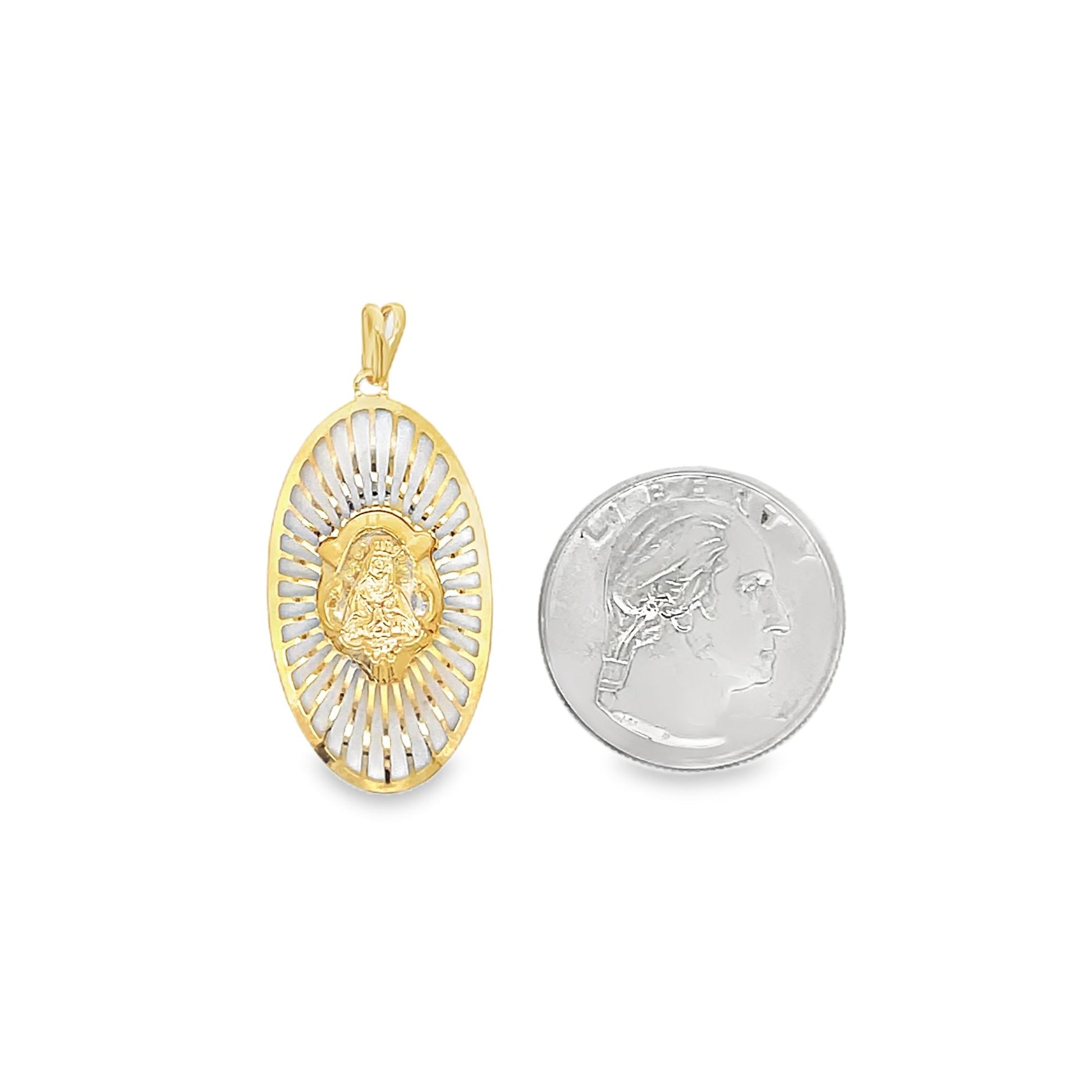 A gold Our Lady of Guadalupe pendant rests next to a US quarter coin for size comparison on a white background.