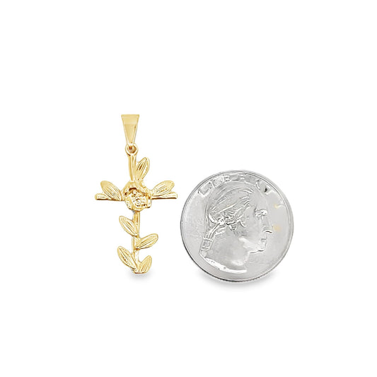 A delicate gold floral cross pendant sits beside a US quarter for size comparison on a white background.