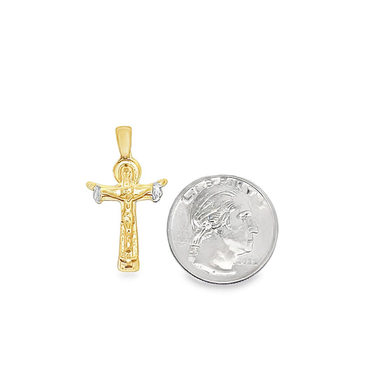 A gold crucifix pendant rests next to a US quarter coin to show its size.